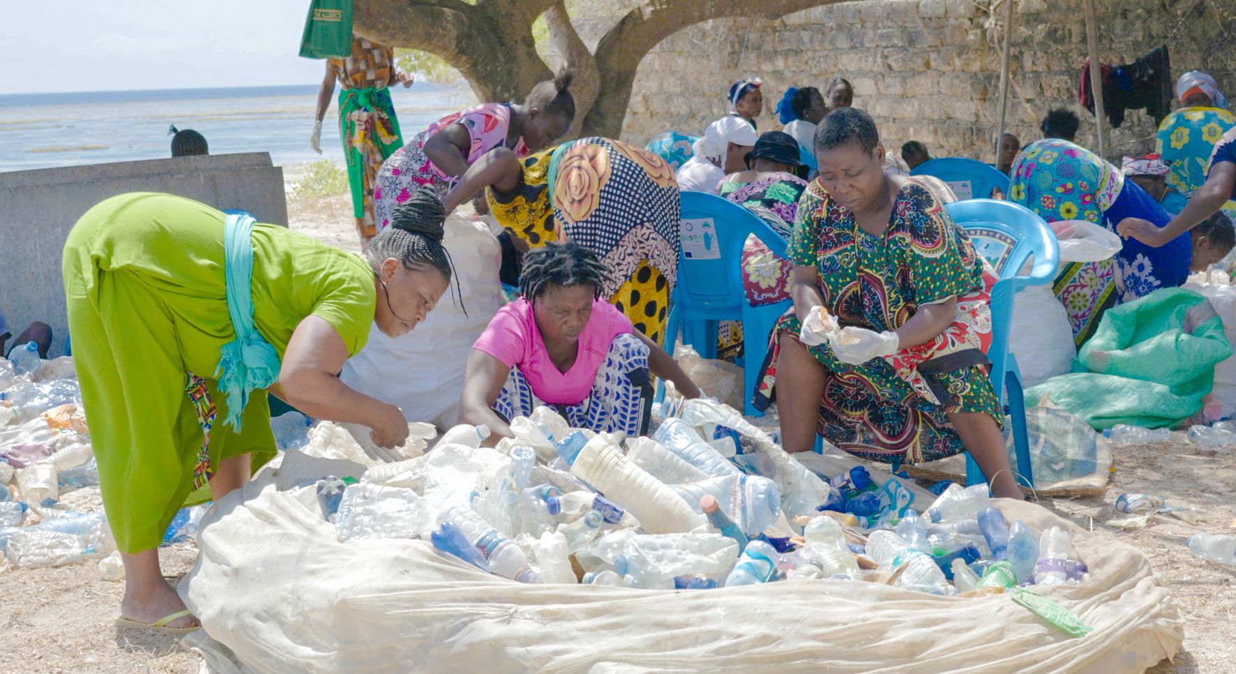 Women in Trash4Cash programme with collected plastic on Kilifi beach
